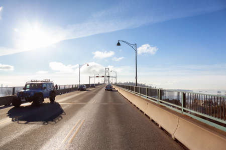 Vancouver, British Columbia, Canada - Dec 12, 2020: Drive across the famous Lions Gate Bridge in the modern Downtown City. Sunny Winter Day.のeditorial素材