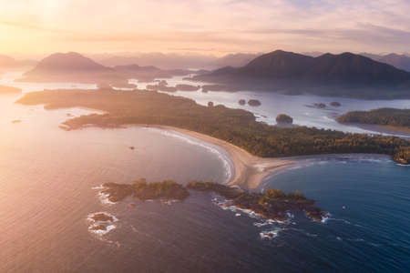 Aerial Canadian Landscape at the West Pacific Ocean Coast. Bright colorful vibrant sunset Art Render. Taken from Airplane in Tofino, Vancouver Island, British Columbia, Canada.の写真素材