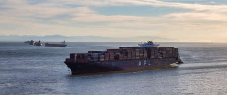 Vancouver, British Columbia, Canada - June 26, 2021: Aerial View from Above of a Cargo Ship arriving to the Port on the West Coast Pacific Ocean during a sunny evening.のeditorial素材