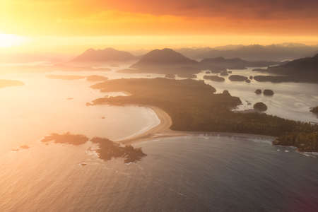 Aerial Canadian Landscape at the West Pacific Ocean Coast. Bright colorful vibrant sunset Art Render. Taken from Airplane in Tofino, Vancouver Island, British Columbia, Canada.の写真素材