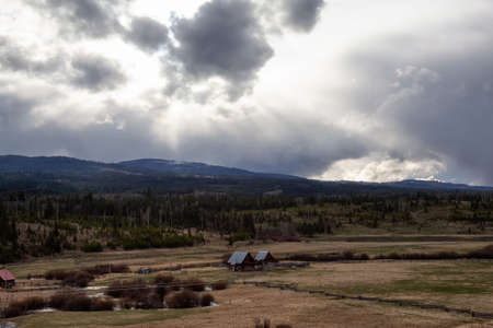 Farm and Farmland in the countryside during a dramatic weather spring day. Taken near Kamloops, British Columbia, Canada.の写真素材