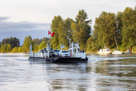Surrey, Greater Vancouver, British Columbia, Canada - July 7, 2021: Barnston Island Ferry going across Fraser River during sunny summer evening.のeditorial素材