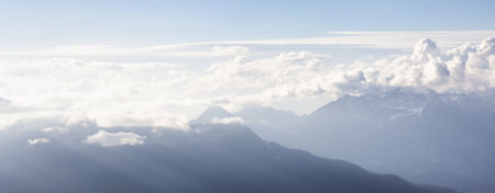 Aerial View from Airplane of Canadian Mountain Landscape. Sunny Summer Clouds before sunset. Taken between Squamish and Whistler, North of Vancouver, BC, Canada.の写真素材