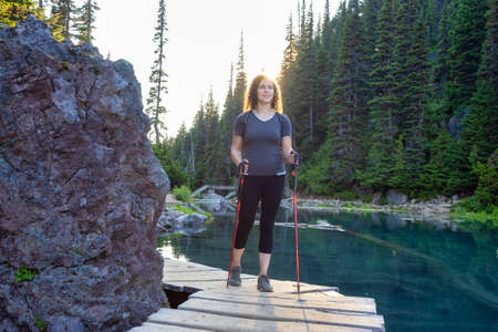 Adventurous White Caucasin Adult Woman Hiking on a trail in Canadian Nature. Garibaldi Lake Hike...