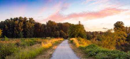 Walking Path in a city park. Dramatic Sunny Summer Sunset Art Render. Colony Farm Regional Park,...