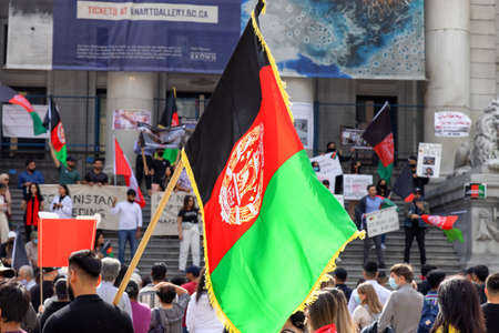 Downtown Vancouver, British Columbia, Canada - August 28, 2021: Crowd of people protesting against the Taliban to Free Afghanistan at the Art Gallery.のeditorial素材