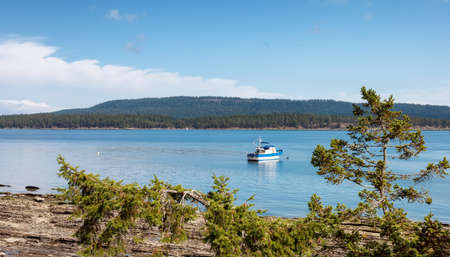 Fishing Boat near the Shore on Pacific Ocean West Coast. Sunny Summer Day. Fernwood Point Beach,...