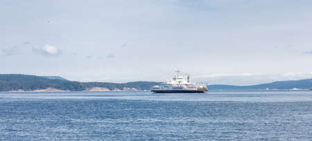 Victoria, Vancouver Island, British Columbia, Canada - August 18, 2021: BC Ferries Boat Arriving at the Terminal in Swartz Bay during sunny summer morning.のeditorial素材