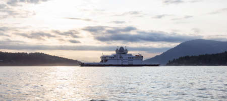 Victoria, Vancouver Island, British Columbia, Canada - August 20, 2021: BC Ferries Boat leaving the Terminal in Swartz Bay during sunny summer sunset.のeditorial素材