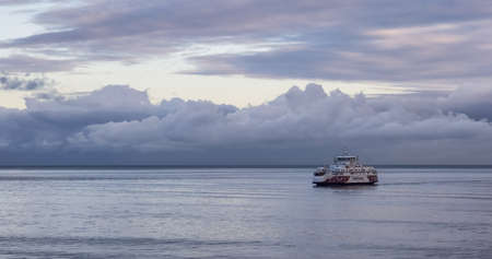 Galiano Island, BC, Canada - August 27, 2021: BC Ferries Boat in Pacific Ocean during cloudy summer morning sunrise.のeditorial素材