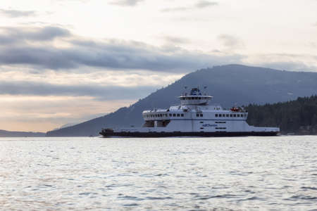Victoria, Vancouver Island, British Columbia, Canada - August 20, 2021: BC Ferries Boat leaving the Terminal in Swartz Bay during sunny summer sunset.のeditorial素材