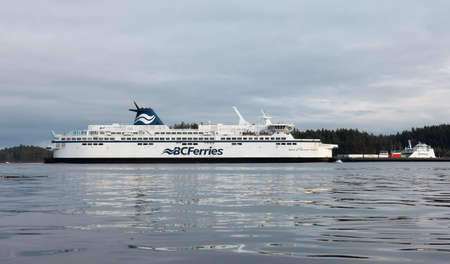 Victoria, Vancouver Island, British Columbia, Canada - August 20, 2021: BC Ferries Boat Arriving to the Terminal in Swartz Bay during sunny summer evening.のeditorial素材