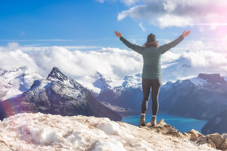 Adventurous Caucasian Woman hiking on top of a Canadian mountain. Taken on Panorama Ridge,...