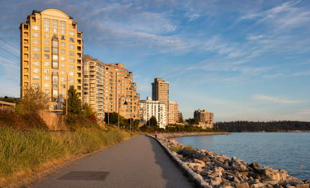 Walking Trail in a modern city on the West Coast of Pacific Ocean. West Vancouver Centennial Seawalk, British Columbia, Canada. Sunny Summer Sunset.の写真素材
