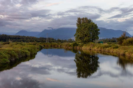 River in a city park. Colorful Summer Sunset. Colony Farm Regional Park, Port Coquitlam, Vancouver, British Columbia, Canada.の写真素材