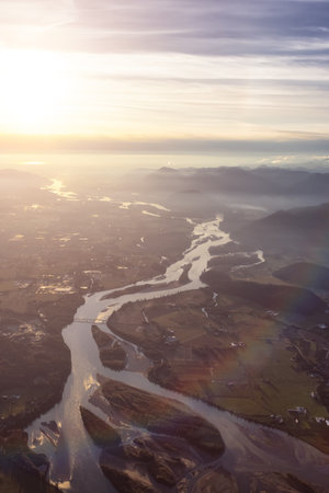 Aerial View of Fraser River and Valley from Airplane. Golden Fall Season Sunset. Chilliwack City, East of Vancouver, British Columbia, Canada.の写真素材