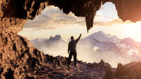 Dramatic Adventurous Scene with Man standing inside an Alien like Rocky Cave Landcspae. 3d Rendering. Sunset Sky. Aerial Mountain Image from British Columbia, Canada. Adventure Conceptの写真素材