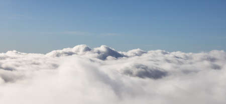 Aerial View from Above the White Puffy Clouds during a sunny day. Taken from Grouse Mountain, North...