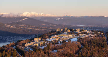 Aerial view of Simon Fraser University, SFU, on Burnaby Mountain. Picture taken from an Airplane in Vancouver Lower Mainland, British Columbia, Canada. Sunny Winter Sunsetの写真素材