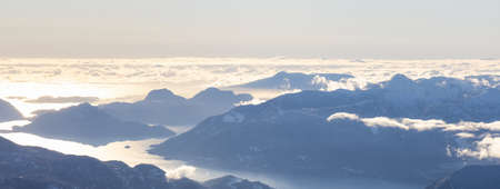 Aerial Panoramic View of Canadian Mountain covered in snow on the West Coast of Pacific Ocean during winter season. near Squamish, North of Vancouver, British Columbia, Canada. Nature Backgroundの写真素材