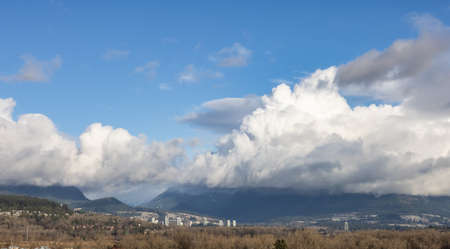 View of Cloudscape over the mountain landscape during a cloudy blue sky sunny day. Taken at Fraser Valley in Vancouver, British Columbia, Canada.の写真素材