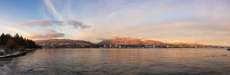 Panoramic View of Modern City, Industrial Site, Lions Gate Bridge, Vancouver Harbour and Mountain Landscape. Winter Sunset. Taken from Stanley Park, Downtown Vancouver, British Columbia, Canada.の写真素材