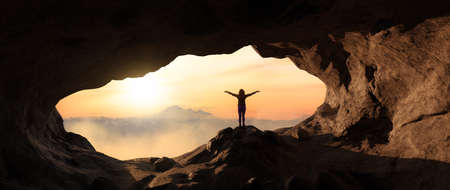 Dramatic Adventurous Scene with Woman standing inside a Rocky Cave Landcspae. 3d Rendering. Sunset...
