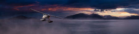 Seaplane Aircraft Flying over the Pacific Ocean Coast. Sunset or Sunrise dramatic Colorful Sky.. 3d Rendering Adventure Dream Concept Artwork. Background Nature Image from Alaska.の写真素材