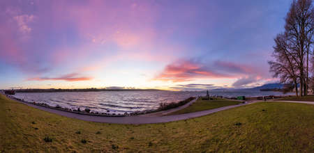 Seawall in Downtown Vancouver, British Columbia, Canada. Colorful Winter Sunset. Modern City on the Pacific Ocean West Coast.の写真素材