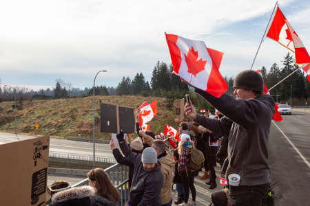 Surrey, Vancouver, British Columbia, Canada - January 29, 2022: People on the Highway Overpass Supporting the Freedom Rally and the protest of the Truck Drivers against Anti Vaccine.のeditorial素材