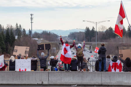 Surrey, Vancouver, British Columbia, Canada - January 29, 2022: People on the Highway Overpass...