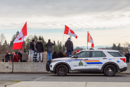Surrey, Vancouver, British Columbia, Canada - January 29, 2022: People on the Highway Overpass Supporting the Freedom Rally and the protest of the Truck Drivers against Vaccine Mandate.のeditorial素材