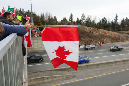 Surrey, Vancouver, British Columbia, Canada - January 29, 2022: People on the Highway Overpass Supporting the Freedom Rally and the protest of the Truck Drivers against Vaccine Mandate.のeditorial素材