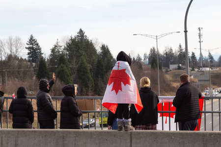 Surrey, Vancouver, British Columbia, Canada - January 29, 2022: People on the Highway Overpass...
