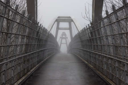 Pedestrian bridge over the Trans-Canada Highway 1 during a winter foggy morning. Surrey, Greater Vancouver, British Columbia, Canada.の写真素材