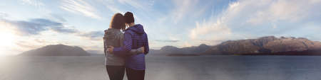 Man and Woman love couple standing on the West Coast of Pacific Ocean. Sunrise or Sunset Sky Art...