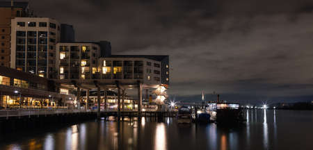 New Westminster, Vancouver, British Columbia, Canada - March 3, 2022: Touristic Attraction in modern city, Westminster Quay, at night.のeditorial素材