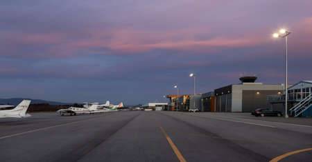 Pitt Meadows, Vancouver, British Columbia, Canada - March 6, 2022: View of Airplanes at the Airport during winter Sunset.のeditorial素材