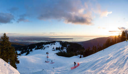 View of Top of Grouse Mountain Ski Resort with the City in the background. North Vancouver, British Columbia, Canada. Sunset Skyの写真素材