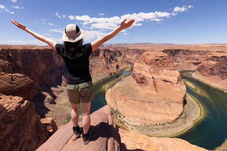 Adventurous Caucasian Woman at Horseshoe Bend in Page, Arizona, United States. Famous Iconic...