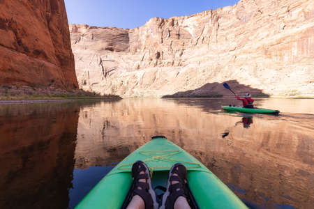 Adventurous Woman on a Kayak paddling in Colorado River. Glen Canyon, Arizona, United States of...