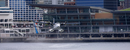 Downtown Vancouver, British Columbia, Canada - May 7, 2022: Harbour Air Seaplane leaving Coal...