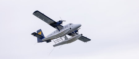 Downtown Vancouver, British Columbia, Canada - May 7, 2022: Harbour Air Seaplane leaving Coal...