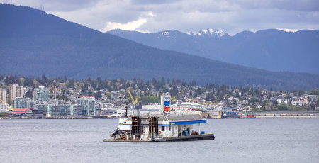 Downtown Vancouver, British Columbia, Canada - May 7, 2022: Chevron Gas Station in Coal Harbour with...