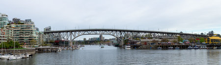 Vancouver, British Columbia, Canada - May 7, 2022: Panoramic View of Granville Island, Downtown City and marina in modern cityscape on the West Coast of Pacific Ocean.のeditorial素材