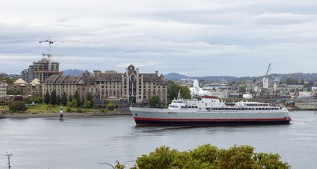 Victoria, Vancouver Island, British Columbia, Canada - June 21, 2022: Ferry in Downtown Victoria Harbour during cloudy day.のeditorial素材