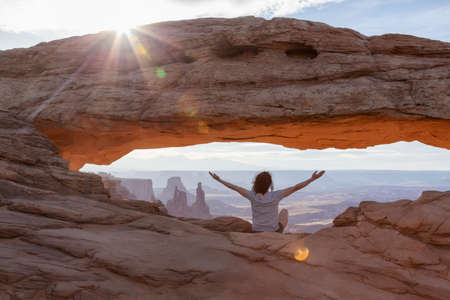 Adventurous Woman at a Scenic American Landscape and Red Rock Mountains in Desert Canyon. Spring...