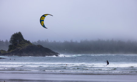 Tofino, Vancouver Island, British Columbia, Canada - July 11, 2022: Man Kitesurfing in the Pacific Ocean on the waves.のeditorial素材