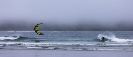 Tofino, Vancouver Island, British Columbia, Canada - July 11, 2022: Man Kitesurfing in the Pacific Ocean on the waves.のeditorial素材