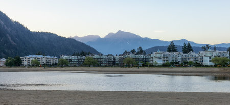 Vacation Homes by the lake and sandy beach. Sunny Summer Morning Sunrise Sky. Harrison Hot Springs, British Columbia, Canada.の写真素材
